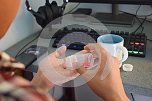 A man taking pills from bottle