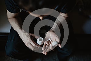 Man taking pills from the container