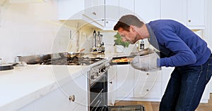 Man taking pizza from oven 4k