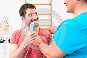 Man taking pulmonary function test with mouthpiece in his hand photo