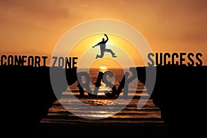 Man taking A Risk and Jumping Over the Cliff To Leave his Comfort zone Forward Success. Business Risk, challenge and success photo