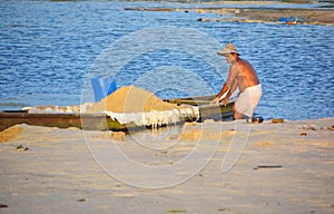 Man taking sand on boat