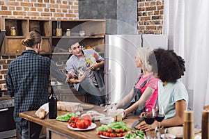 man taking sauces from fridge photo