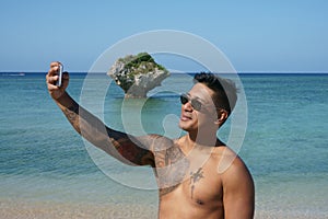 Man taking selfie on beach