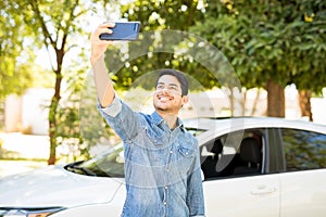 Man taking selfie with his new car