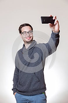 A man is taking a selfie with his phone