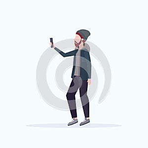 Man taking selfie photo on smartphone camera casual male cartoon character in hat posing on white background flat full
