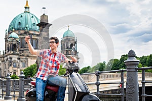 Man taking a selfie during sightseeing tour with Vespa photo