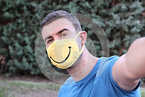 Man taking a selfie wearing protective mask