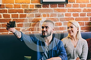 Man taking a selfie with a woman.