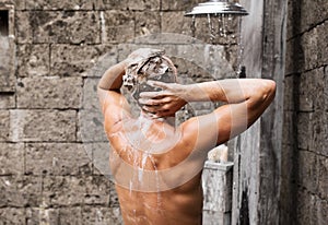 Man taking shower and washing hair