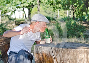 Man taking a swig of alcohol from a bottle