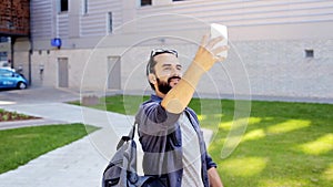 Man taking video or selfie by smartphone in city 32