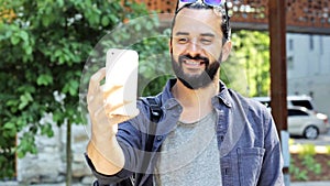 Man taking video or selfie by smartphone in city 42