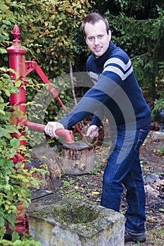 Man taking water from water well
