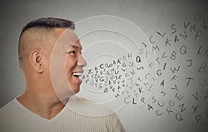 Man talking with alphabet letters coming out of open mouth