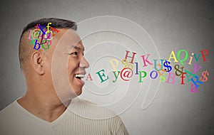 Man talking with alphabet letters coming out of open mouth