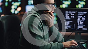 IT man talking cellphone coding computer at workplace closeup. Coder guy calling