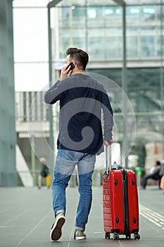 Man talking on mobile phone in airport