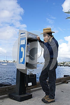 Man talking on Pay Phone