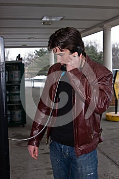 Man talking on a payphone