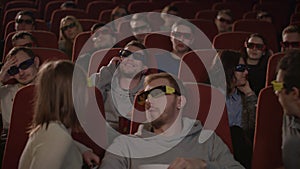 Man talking on phone in cinema hall. Uncultured man disturb people in cinema