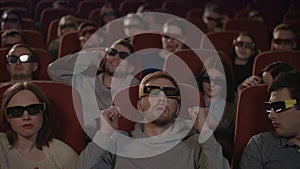 Man talking on phone in cinema. Man speaking mobile phone and disturb people