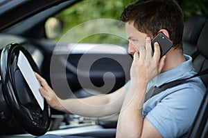 man talking on phone while driving car
