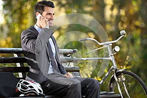 Man talking on the phone with his bicycle