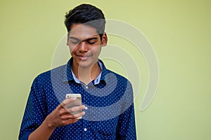 Man talking on the phone india summer holidays.stylish young indian male freelancer working with laptop freelance