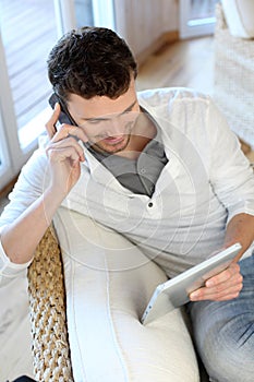 Man talking on the phone using tablet