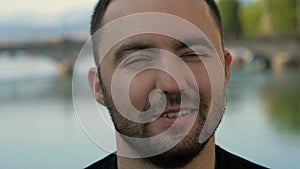 Man talking to camera outdoors.