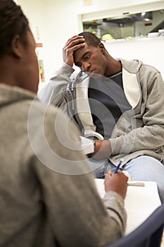 Man Talking To Counsellor Who Takes Notes photo