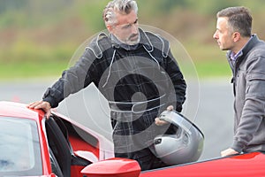 Man talking to racing driver