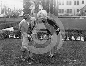 Man talking to woman while golfing photo