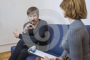 A man talks about his problems to a psychologist. Psychological treatment