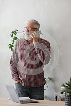 man talks on the phone with colleagues or business partners, solving financial and legal problems