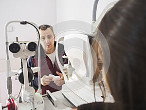 Man talks to the Ophthalmologist during an eyes exam with Slit L