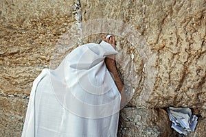 Man in tallit praying at Wailing Wall in Jerusalem, Israel.