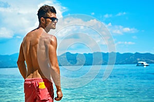 Man Tanning With Sunblock Skin Cream On Summer Beach.