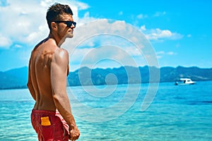 Man Tanning With Sunblock Skin Cream On Summer Beach.