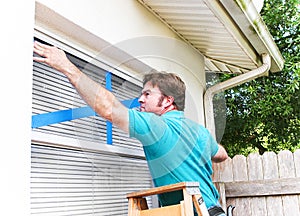 Man Taping His Windows