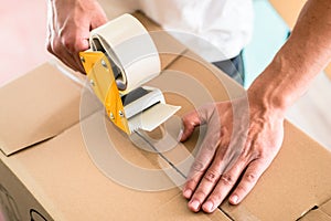 Man taping packing case