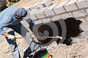 Man tarring a house foundation photo