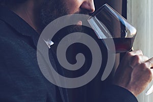 Man tasting a glass of red wine