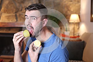 Man tasting a raw lemon