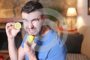 Man tasting a raw lemon