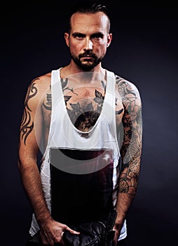 A man with tattooes on his arms. Silhouette of muscular body. ca