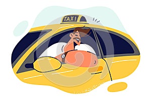 Man taxi driver smiles sitting behind wheel and looking out window of yellow car
