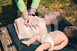 Man teaches indirect heart massage on mannequins, on the simulator for first aid